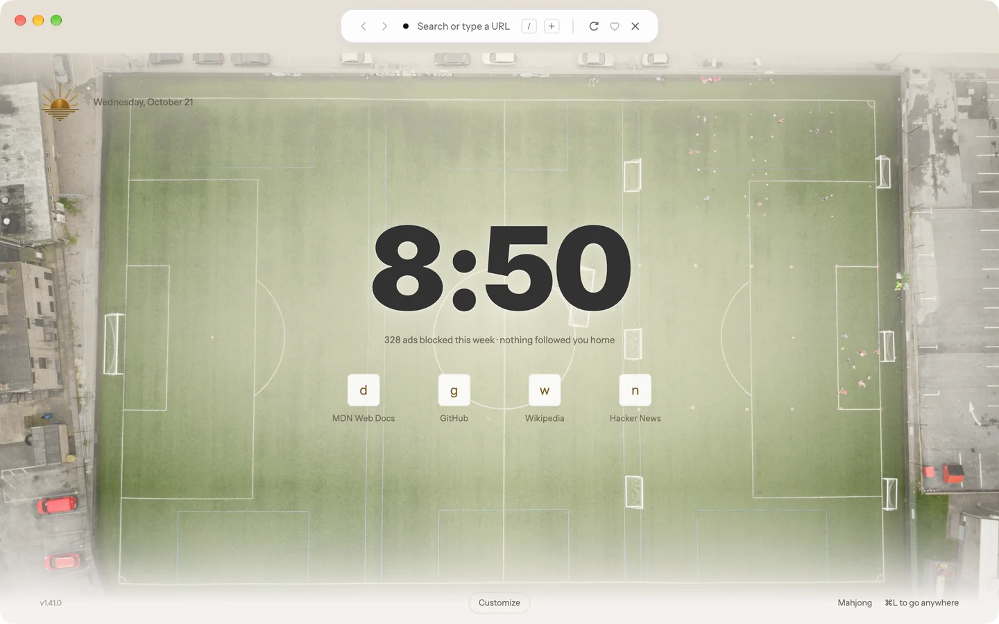 A heavy graphite clock over an overhead view of a football pitch. (Photo: matthew Feeney, Unsplash)